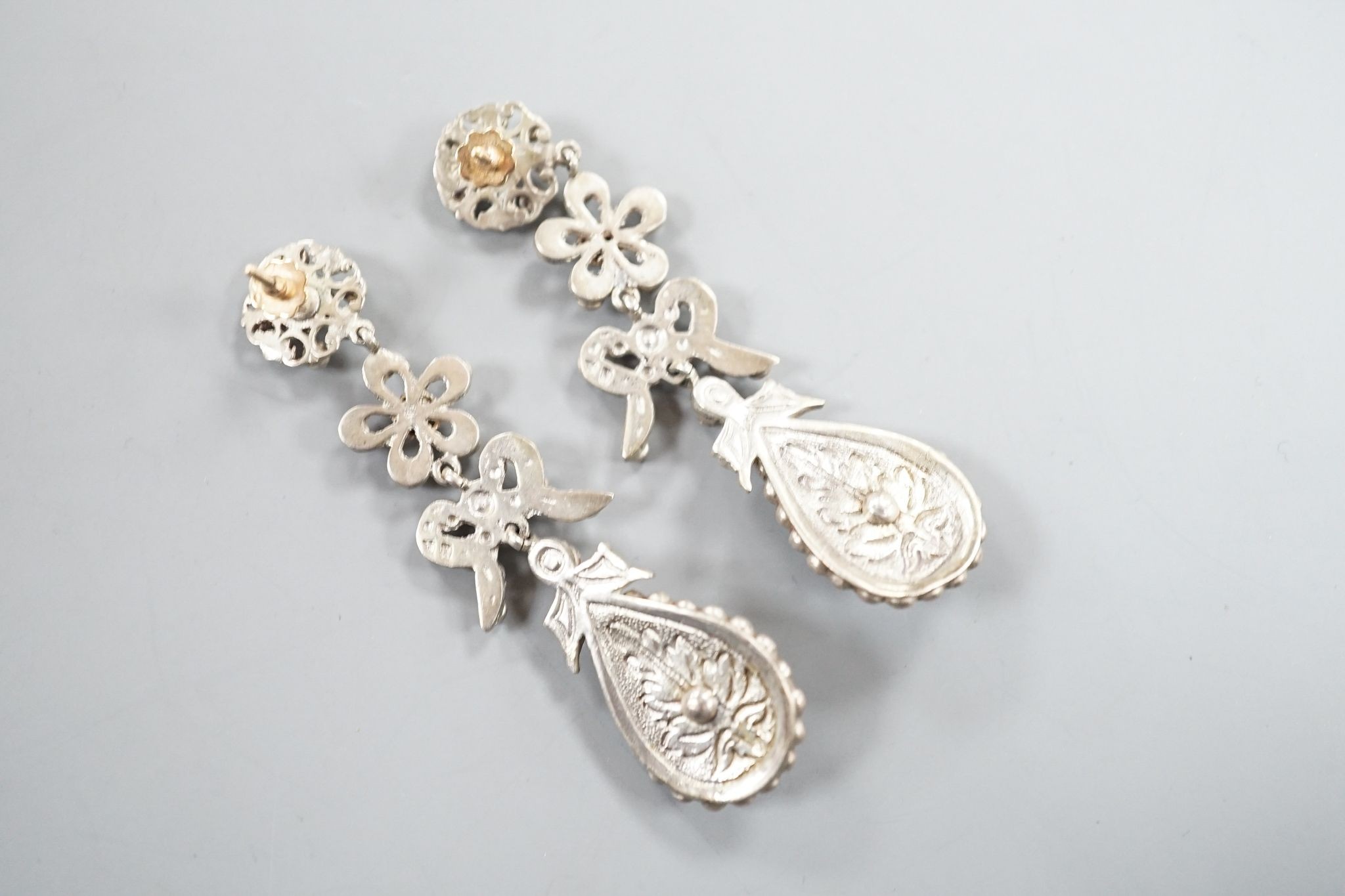 A pair of white metal and two colour paste drop earrings, 68mm, in a gilt tooled leather box.